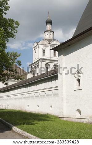 MOSCOW, RUSSIA, MAY 30, 2015 Andronikov Monastery of the Saviour, the tower of the monastery wall and The Archangel Michael church
