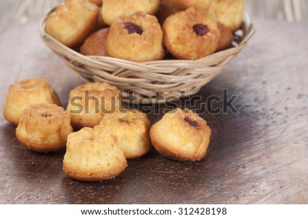Cakes with jam in a basket, closeup shot