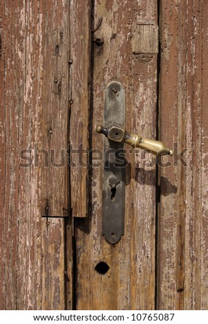 Lock on old brown ruined wooden door