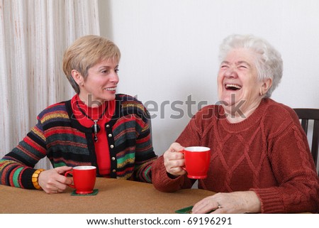 Senior and mature womans drinking caffee and laughing