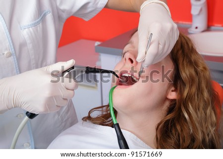Dentist splashing teeth after drilling