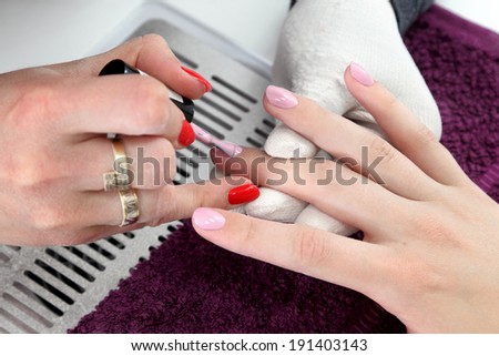 Finger nail treatment, painting with brush and lacquer