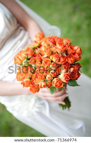The bride have orange wedding bouquet