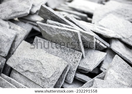 Close up gray stone tiles on stack.
