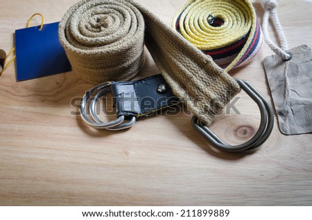 set of fabric belt and label on wood background