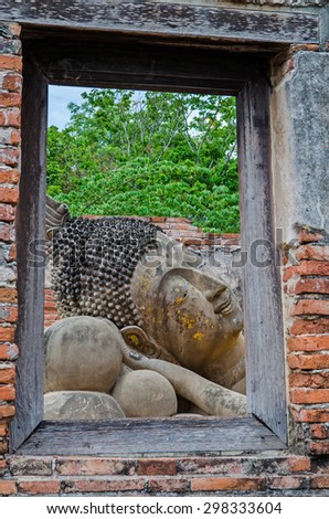 Wooden window frame with Buddha head statue. Wat Putthaisawan, Ayutthaya,Thailand.Public place