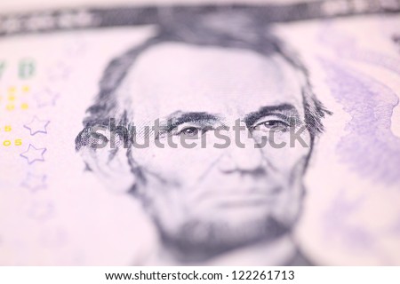 Abraham Lincoln, the 16th President of the United States, on five dollars bill.