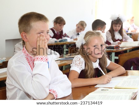 Lesson in Ukrainian schools. Children write in a notebook