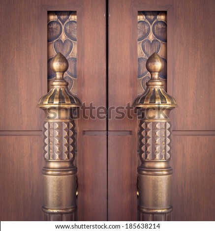 vintage door handles on an old wooden door.