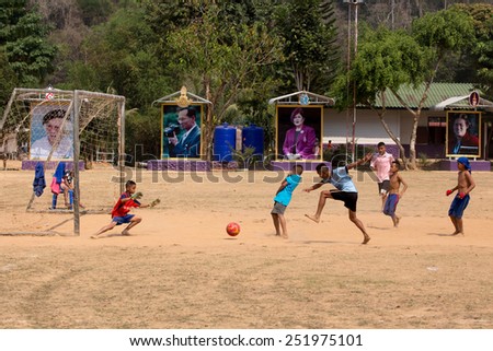 PHETCHABURI, Thailand - FEBRUARY 08, 2015: Karen hill tribel boy playing football in ground field in the school at Ban Bangkloy Phetchaburi, Thailand