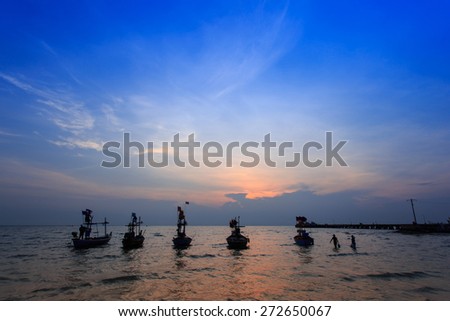 sun rise over the fishing boats at Hua hin beach in Thailand