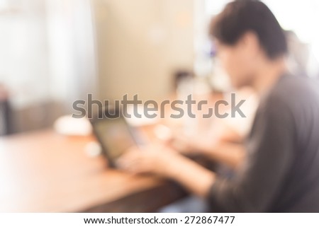 blur the background of multitasking man using tablet laptop and