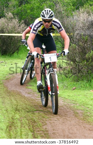 SANTIAGO, CHILE - SEPTEMBER 27: Rider number 1 being chased closely during a descent on Alpes Cup, mountain bike competition on September 27, 2009 in Santiago, Chile.