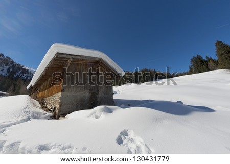 Old wood cabin house in the soft snow background