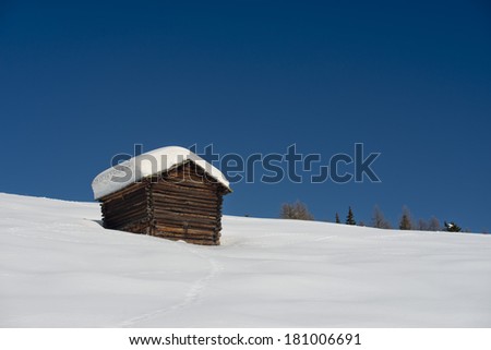 Isolated wood mountain house cabin hut covered by snow