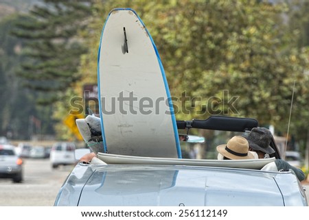 surf board in a vintage car in California