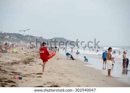 LOS ANGELES, USA - AUGUST 3, 2014 - people on Zuma sandy  beach in summer time