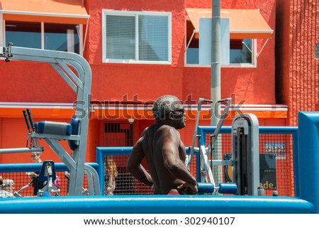 LOS ANGELES, USA - AUGUST 5, 2014 - excercise of black man in muscle beach  in venice beach  in los angeles