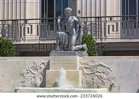 WASHINGTON DC, USA - APRIL 6, 2014: Puck Statue outside of the Folger Shakespeare Library in Washington DC on April 6, 2014. A statue of Shakespeare\'s play character sprite Puck sits above a fountain