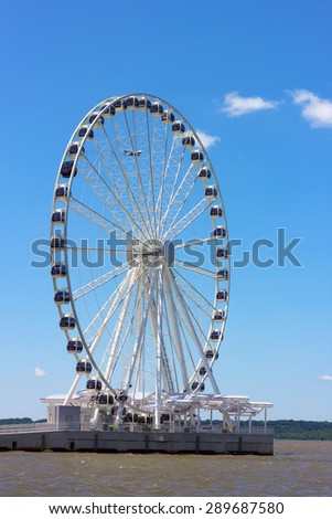 Ferris of National Harbor pier in Maryland, USA. National Harbor waterfront on a bright sunny day.
