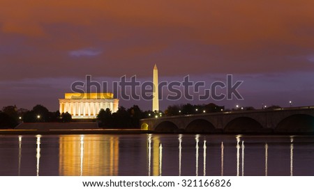 Washington Monument, Lincoln Memorial and Arlington Memorial Bridge at night. Illuminated major national capital attractions with light reflections in the Potomac river.