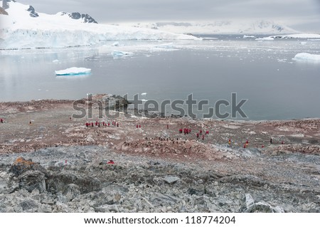 Dramatic landscape in Antarctica, penguins and people