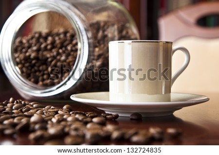 Cup of espresso and coffee grains. Coffee background.