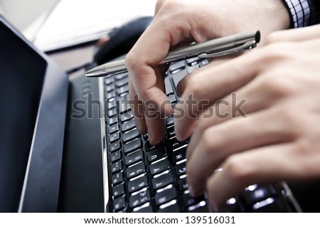 Hands on a laptop keyboard - a journalist, writer or a programmer at work