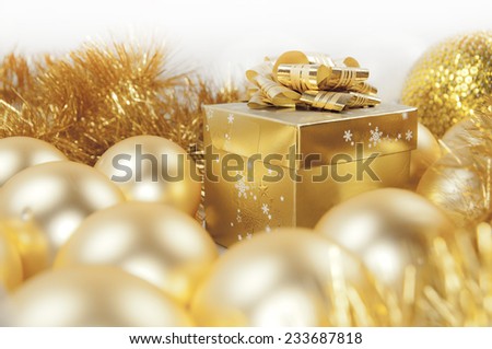 Golden christmas gift box, baubles and ornaments - studio shot