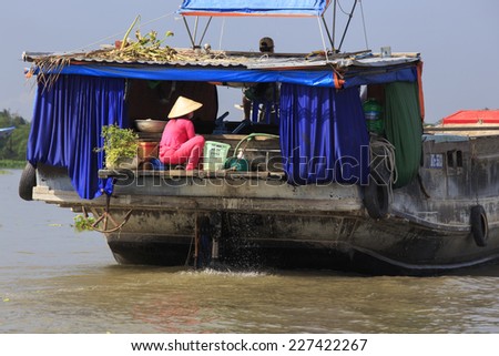 LE BINH, VIETNAM - APRIL 23: People on a boat at the floating market, Vietnam on April 23, 2014