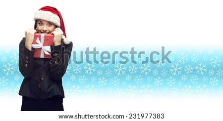 business woman in santa hat holding gift over winter snowflakes background