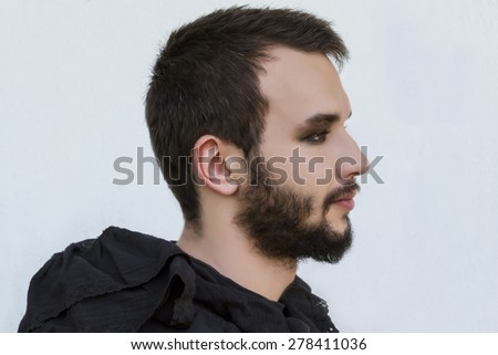 Portrait of a male model with Smokey eyes and black clothes