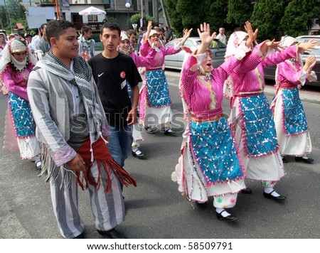 SZCZYRK, POLAND - AUGUST 1: Participants of the 47th Beskidy Highlanders Week of Culture (TKB), the biggest folk culture event in Eastern Europe, parade through the city, folk group from Turkey on August 1, 2010 in Szczryk