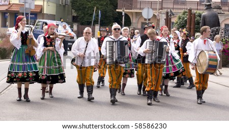 ZYWIEC, POLAND - AUGUST 5: Participants of the 47th Beskidy Highlanders Week of Culture (TKB), the biggest folk culture event in Eastern Europe, parade through the city, folk group from Poland on August 5, 2010 in Zywiec, Poland