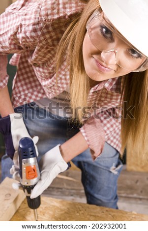 young woman working as wood builder