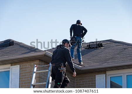 Two roofers inspecting a damaged roof Stock foto © 