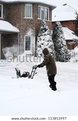 Man clearing snow from driveway