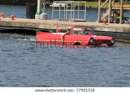 GRAVENHURST, ONTARIO, CANADA - JULY 10: Young couple driving a converted car into a boat during the annual Clssic Boat Show July 10, 2010 in Gravenhurst, Ontario,Canada