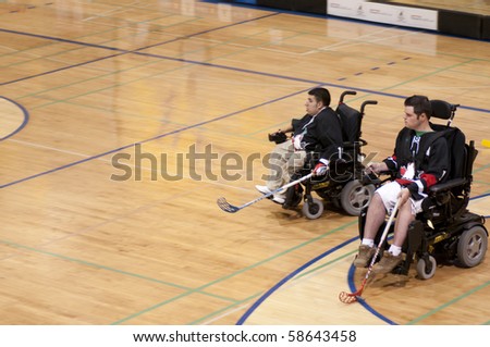 TORONTO, ONTARIO - AUGUST 7: Two disabled young athletes in the wheelchair play in the Power Hockey Cup on August 7, 2010 at Ryerson University in Toronto, Ontario, Canada
