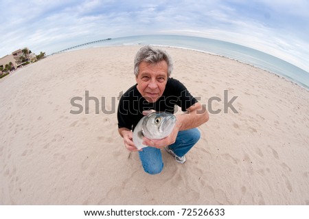 Man with fish - through a fish-eye lens