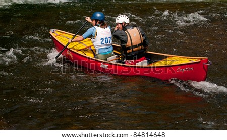 MINDEN, ONTARIO - SEPT. 10:  Unidentified mixed pair competes at Open Canoe Slalom Race, 2011 at Gull River on September 10, 2011 in Minden, Ontario, Canada.
