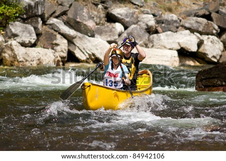 MINDEN, ONTARIO - SEPT 10. Unidentified man and woman compete at Open Canoe Slalom Race, 2011 at Gull River in Minden, Ontario, Canada. Sept. 10, 2011