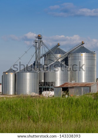 Modern farm silo and an old barn