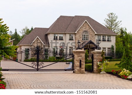 Luxury home with a double wrought-iron gate