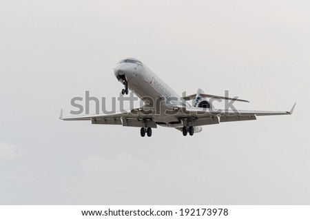 TORONTO INTERNATIONAL AIRPORT - MAY 9, 2014: American Eagle jetliner with engaged landing gear landing at Toronto Pearson International airport.