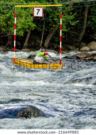 MINDEN, ONTARIO - SEPTEMBER 6, 2014: An unidentified contestant competes at 2014 Open Canoe Slalom Race at Gull River in Minden, Ontario, Canada.