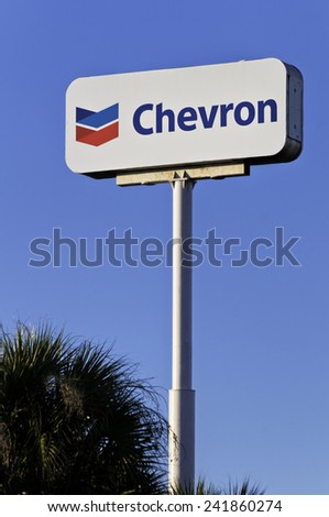WEST PALM BEACH, FLORIDA - JANUARY 20, 2012: Chevron energy company sign against blue sky in West Palm Beach, Florida. Chevron operates over 3,600 service stations.