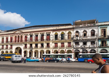HAVANA - FEB 13: Busy street scene with old buildings and cars on Paseo Del Prado in Old Town of Havana on February 13, 2015.