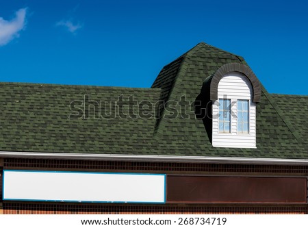 Dormer window over a store sign