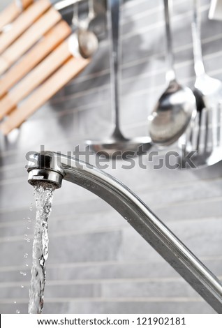 Kitchen faucet with dropping water and kitchen tools